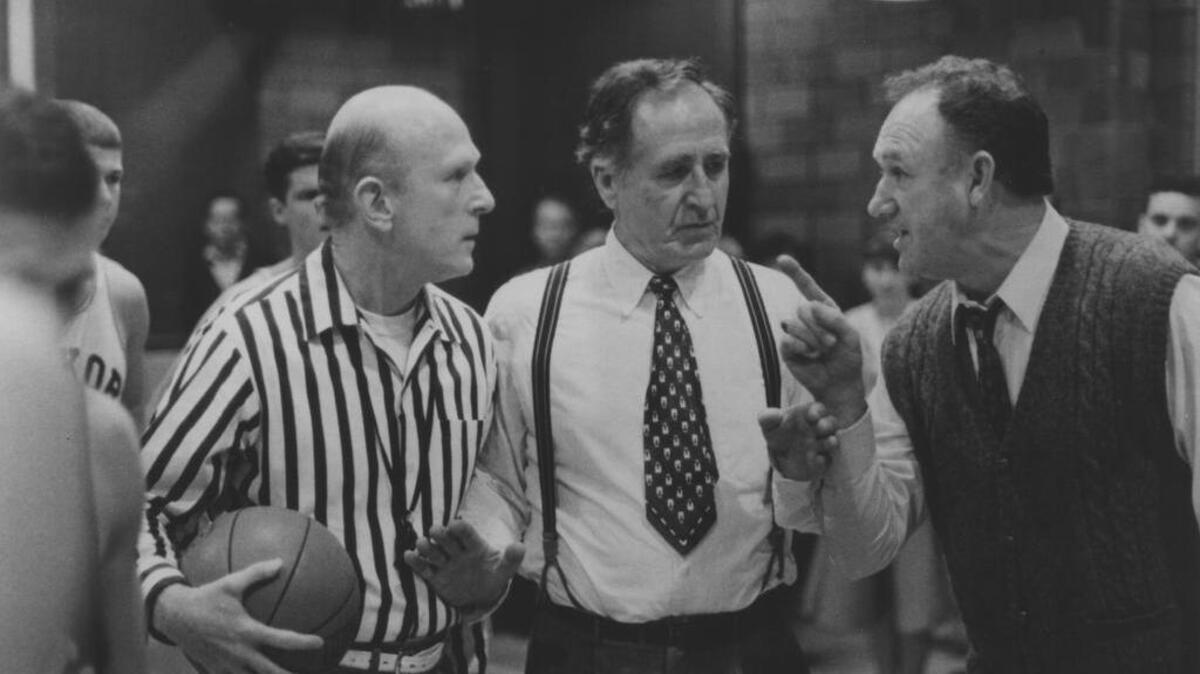 Cletus (Sheb Wooley) and Coach Norman Dale (Gene Hackman) argue with a referee in “Hoosiers.”