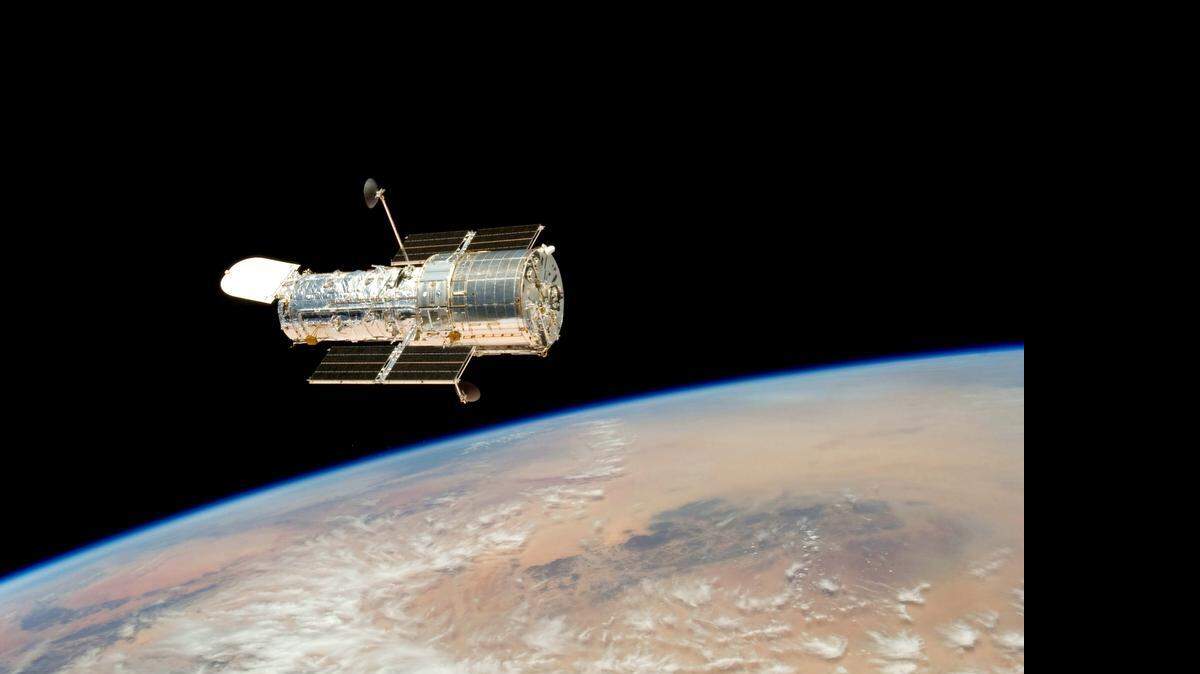 
The Hubble telescope hovering over the Earth.
