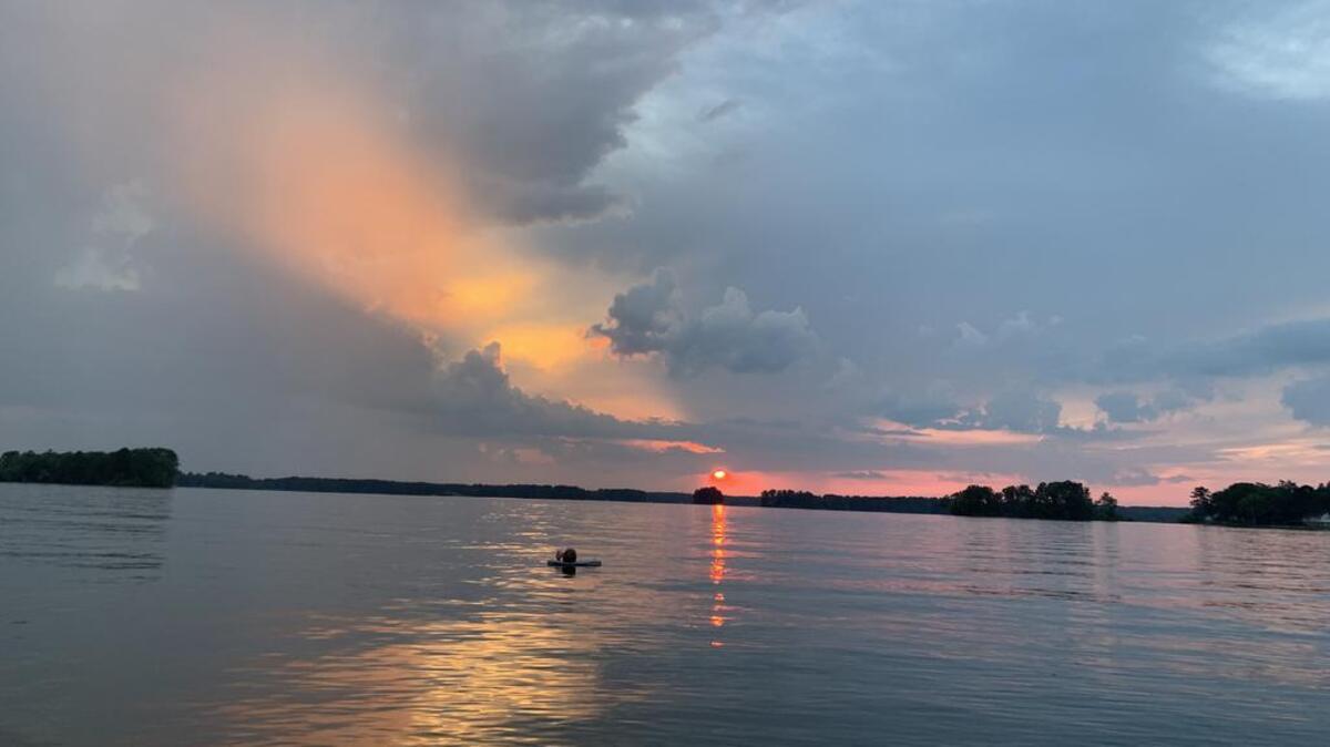 Beautiful sunset at Lake Murray with my husband, Joey McCue, floating in the water.