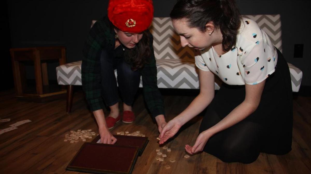 Go Columbia’s Sarah Ellis, left, and Erin Shaw try to figure out clues to defuse a “bomb” during a session at Escape Plan.