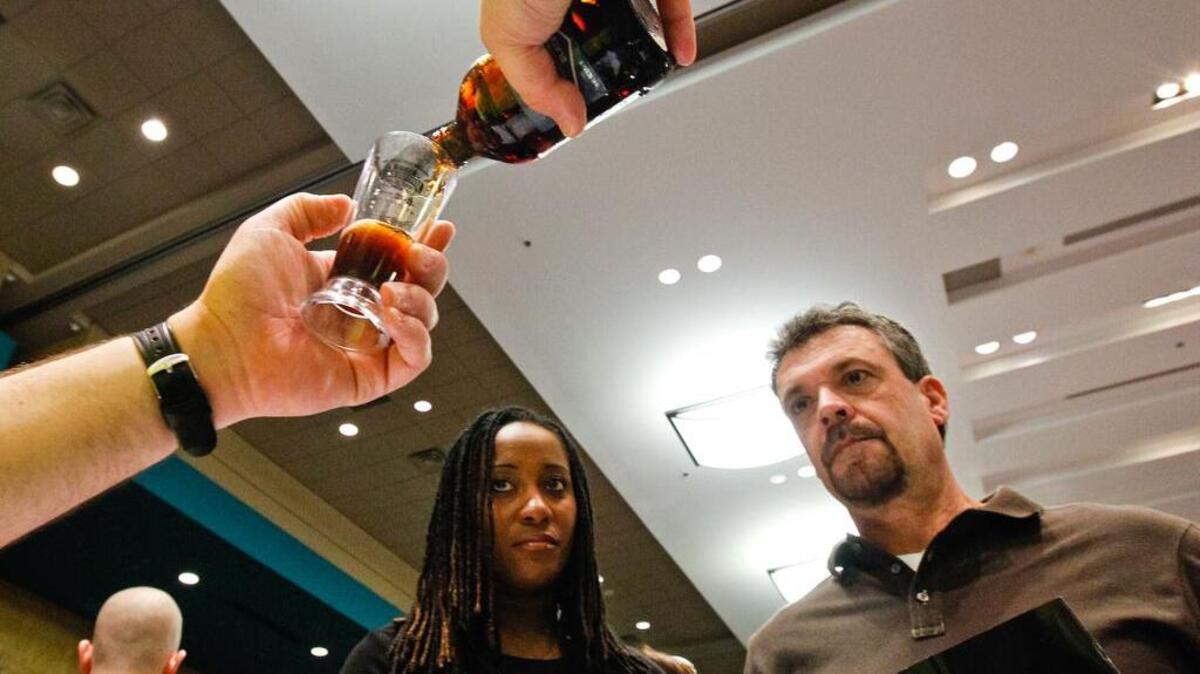 Guests watch a bartender pour tastes of Full Sail lager at a previous World Beer Festival.