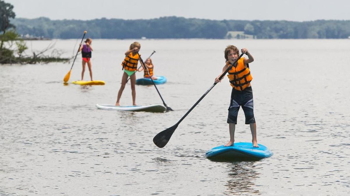 Kids learn paddleboarding at Lake Murray.