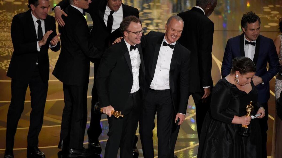 Tom McCarthy, center left, and Michael Keaton, center right, accept the award for best picture for "Spotlight" at the Oscars on Sunday, Feb. 28, 2016, at the Dolby Theatre in Los Angeles.