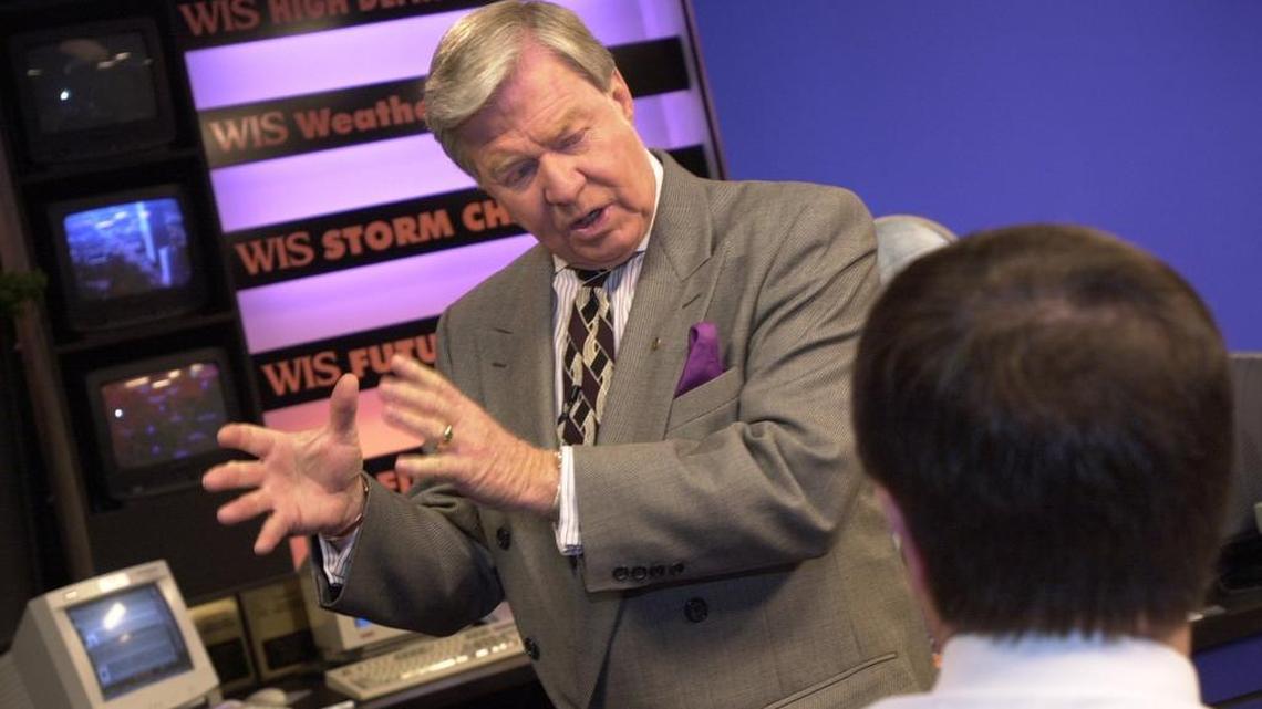 Joe Pinner talks to his fellow anchorman after the news program in the file photo from 2000.