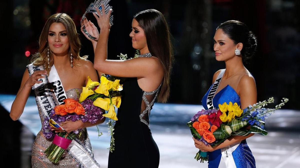 Former Miss Universe Paulina Vega, center, removes the crown from Miss Colombia Ariadna Gutierrez, left, before giving it to Miss Philippines Pia Alonzo Wurtzbach, right, at the Miss Universe pageant on Sunday, Dec. 20, 2015, in Las Vegas. Gutierrez was incorrectly named the winner before Wurtzbach was given the Miss Universe crown.