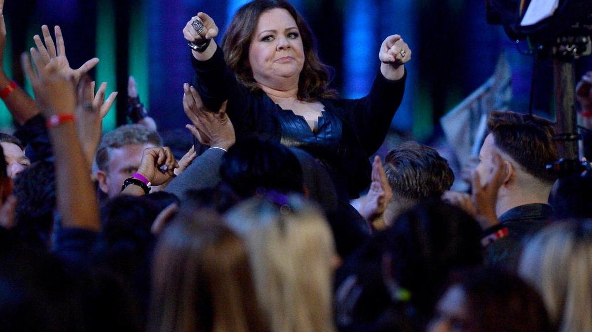Melissa McCarthy crowd surfs toward the stage before accepting the comedic genius award at the MTV Movie Awards at Warner Bros. Studio on Saturday, April 9, 2016, in Burbank, Calif.