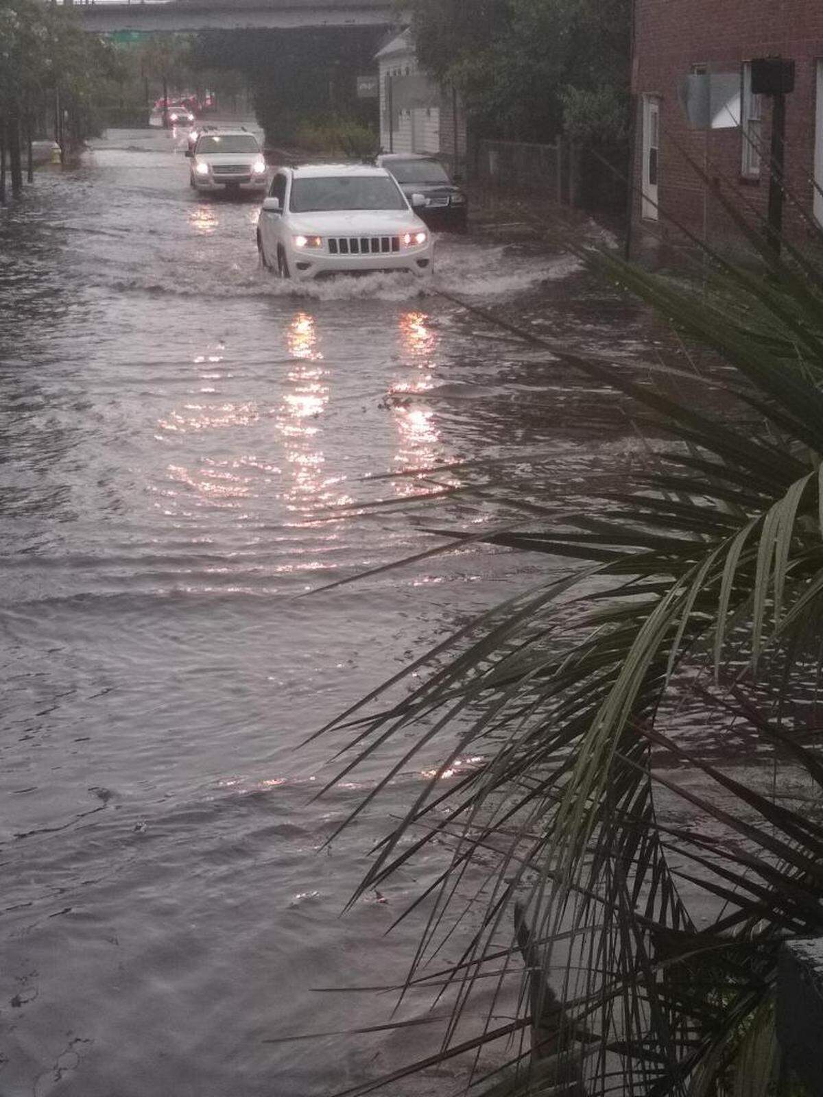 Cars drive through a flooded intersection close to the Crosstown in Charleston, SC, early Wednesday, Sept. 4, 2019, as Hurricane Dorian.