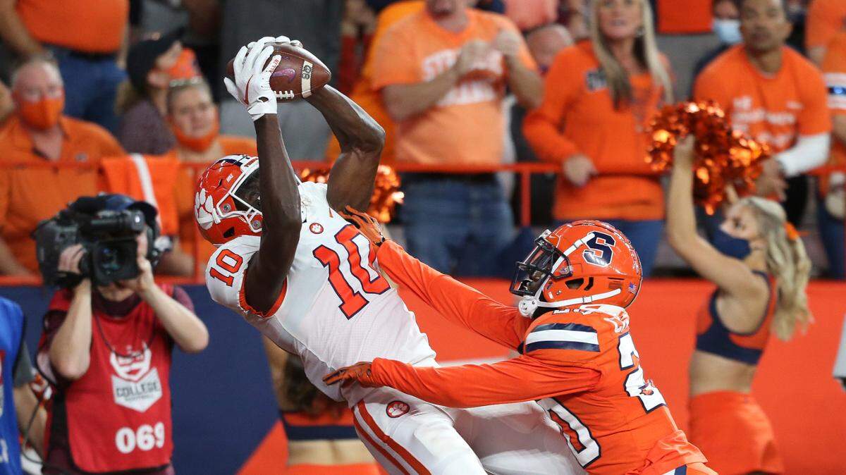 Clemson wide receiver Joseph Ngata (10) makes a touchdown catch while defended by Syracuse defensive back Darian Chestnut (20) during the second quarter of an NCAA football game in Syracuse, N.Y., Friday, Oct. 15, 2021. (AP Photo/Joshua Bessex)