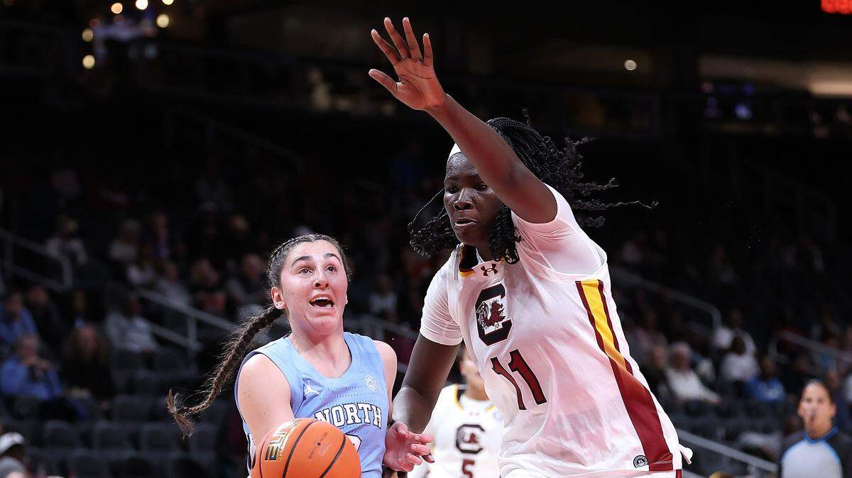 Lanie Grant #0 of the North Carolina Tar Heels drives against Madina Okot #11 of the South Carolina Gamecocks during the first quarter of The Bad Boy Mowers Series between the North Carolina Tar Heels and South Carolina Gamecocks at State Farm Arena on October 30, 2025 in Atlanta, Georgia.
