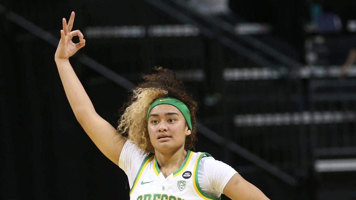 Oregon’s Te-Hina Paopao, left, and Nyara Sabally celebrate one of Paopao’s 3-point shots against Stanford during the second half Feb. 20, 2022.