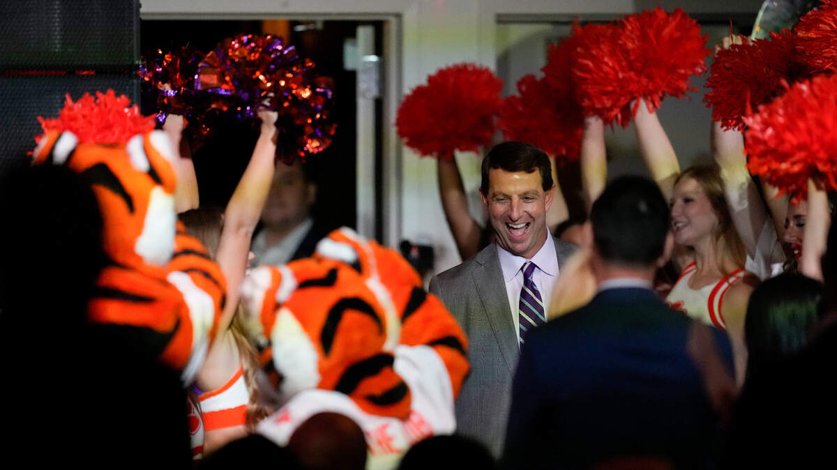 Cheerleaders wave their pom-poms as Clemson head coach Dabo Swinney arrives at a coaches luncheon ahead of the Orange Bowl NCAA college football game, Thursday, Dec. 29, 2022, in Miami, Fla. Clemson will face Tennessee in the Orange Bowl on Friday, Dec. 30.