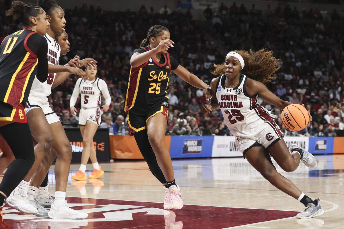 South Carolina's Raven Johnson (25) drives around University of Southern California's Kara Dunn (25) during the first half of action of their women's basketball game against University of Southern California in the first round game of the NCAA Tournament at Colonial Life Arena on Monday, March 23, 2026.