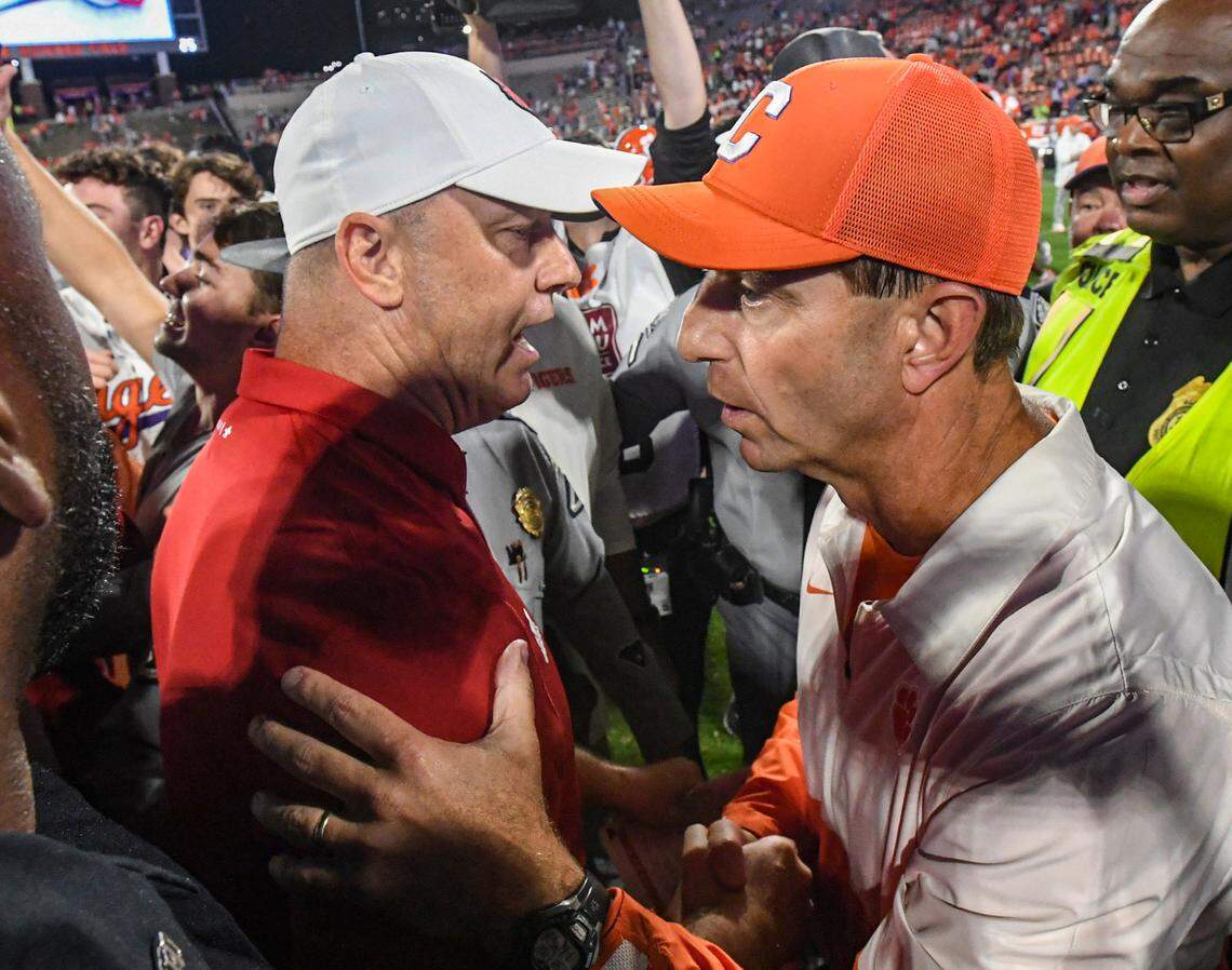 Nov 2, 2024; Clemson, South Carolina, USA; Louisville Cardinals head coach Jeff Brohm (left) meets with Clemson Tigers head coach Dabo Swinney after a game at Memorial Stadium. Louisville won 33-21.