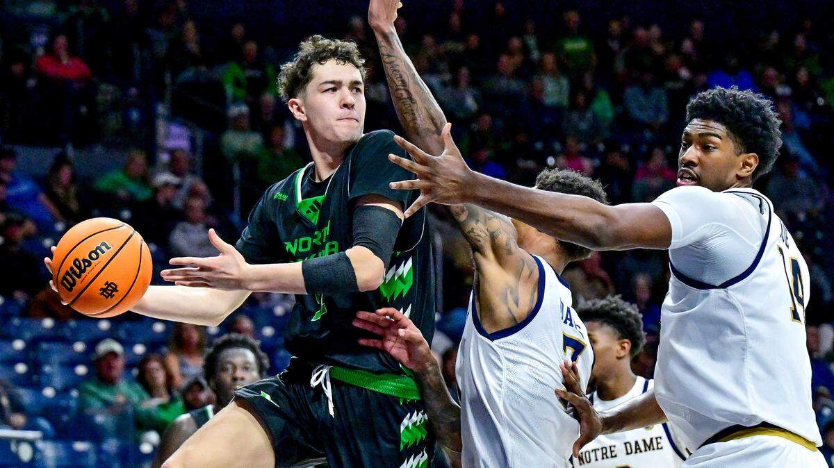 North Dakota Fighting Hawks guard Treysen Eaglestaff (52) passes the ball as Notre Dame Fighting Irish forward Tae Davis (7) and forward Kebba Njie (14) defend in the second half at the Purcell Pavilion.