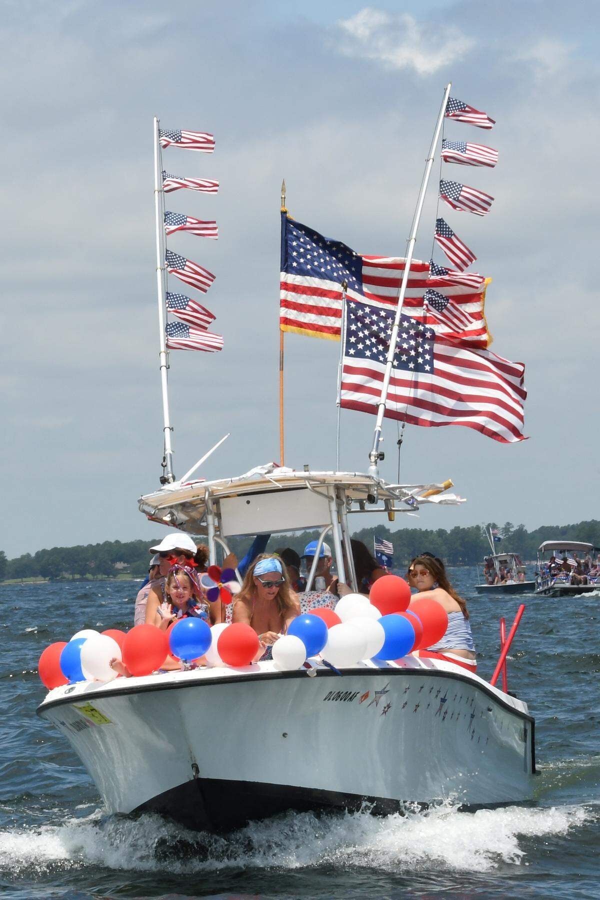 Patriotically decorated boats of all shapes and sizes line up every year for the Fourth of July Boat Parade at Lake Murray.