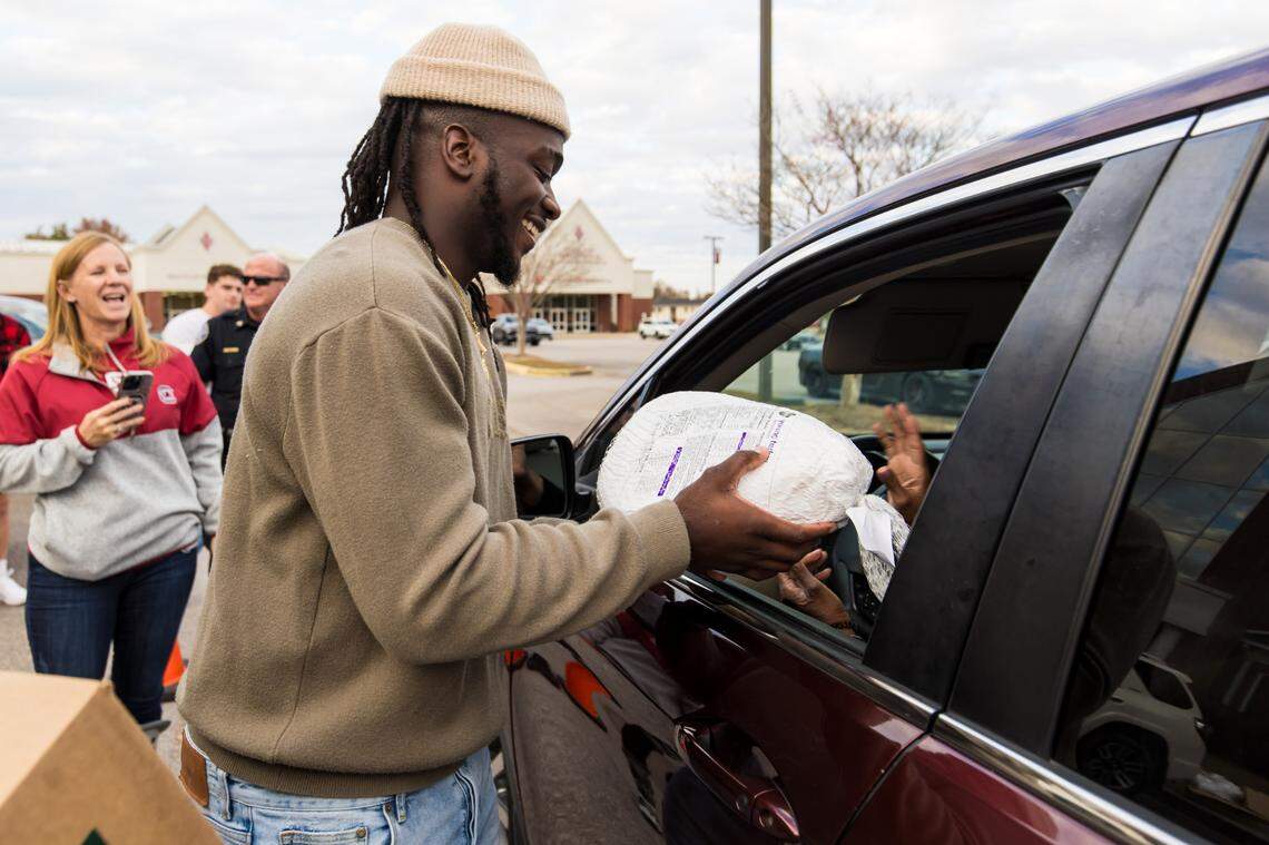 Gamecocks football player Dakereon Joyner hands out turkeys and other Thanksgiving food at Brookland Baptist Church in West Columbia, SC, Monday, Nov. 20, 2023.