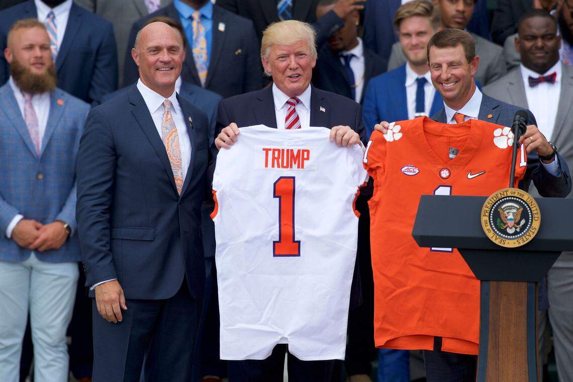 Jun 12, 2017; Washington, D.C., USA; United States President Donald Trump (center) holds up a Clemson Tigers football jersey along with Clemson University president James P. Clements (left) and head coach Dabo Swinney (right) on the White House South Lawn during a ceremony to celebrate their 2016 NCAA Football National Championship. Mandatory Credit: Rafael Suanes-USA TODAY Sports