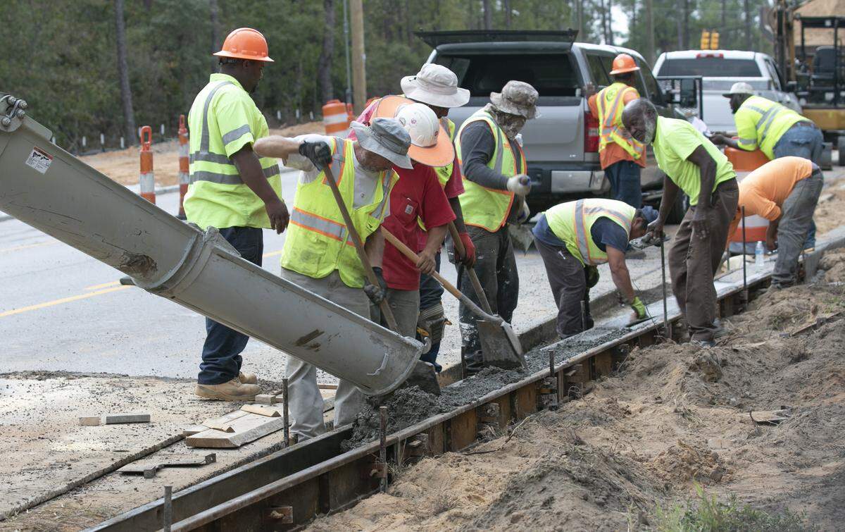 Workers with C.R. Jackson, work on a road widening and sidewalk project on Clemson and Earth roads. The project is one of the Richland County penny tax projects. 10/15/19