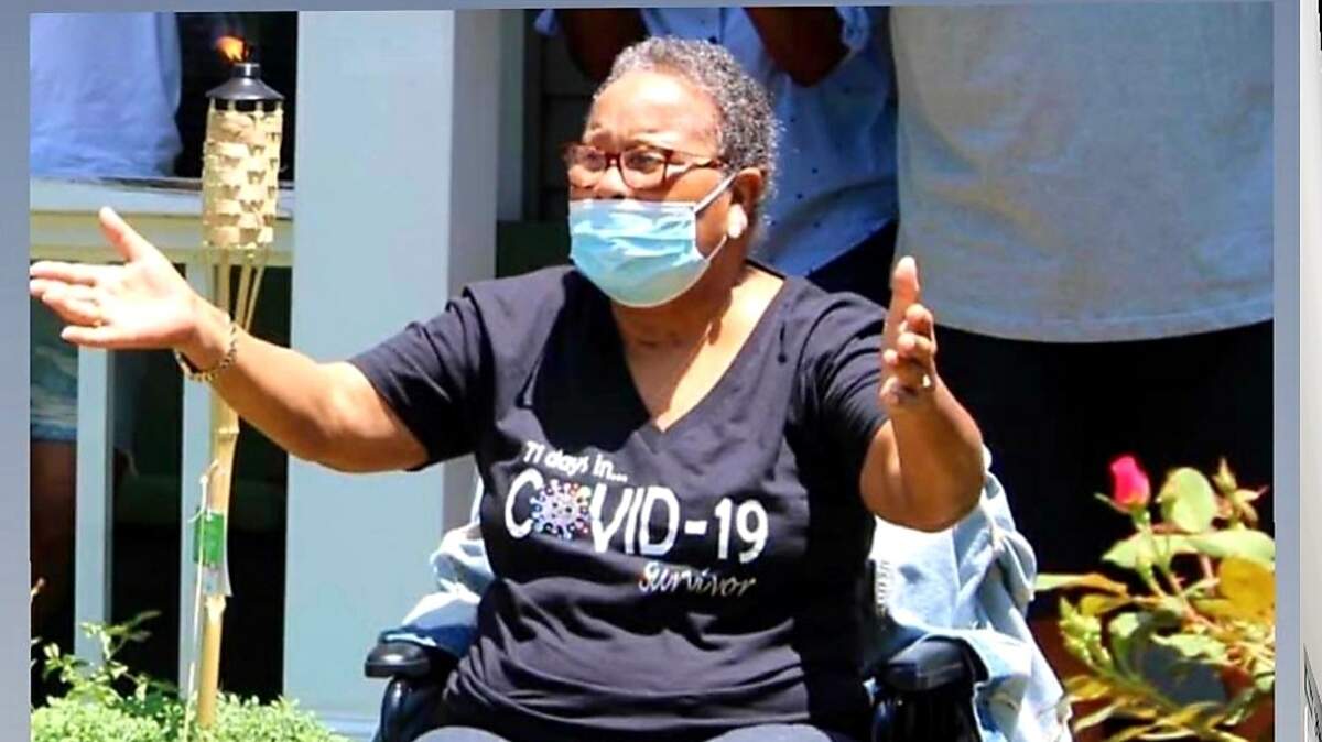 Carolyn Harris watches a parade in her honor after surviving COVID-19.