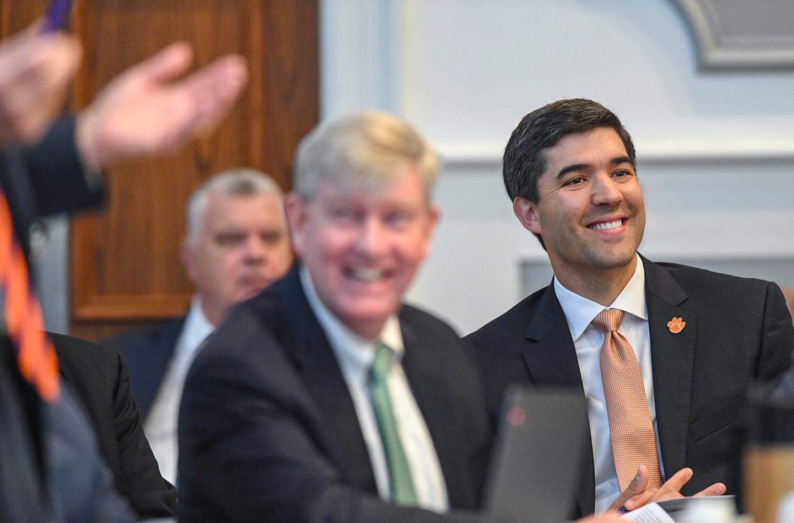 Graham Neff, right, Clemson University Athletic Director laughs as Judge Perry H. Gravely responds to attorney Rush Smith, discussing grant of rights at the Pickens County Courthouse in Pickens, S.C. Friday, July 12, 2024.