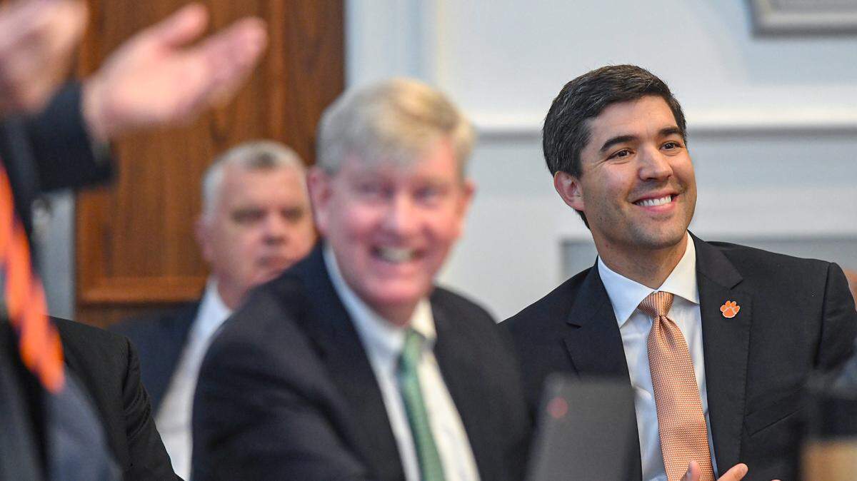 Graham Neff, right, Clemson University Athletic Director laughs as Judge Perry H. Gravely responds to attorney Rush Smith, discussing grant of rights at the Pickens County Courthouse in Pickens, S.C. Friday, July 12, 2024.