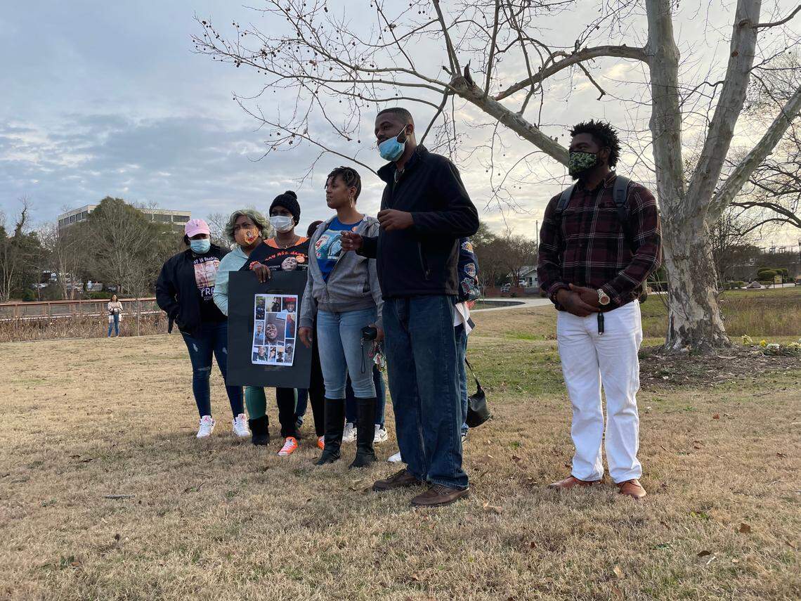 Justin Hunt of the South Carolina Black Activist Coalition speaks next to John Tyler of One Common Cause of the Midlands and relatives of shooting victims at an event to bring awareness about gun violence prevention.