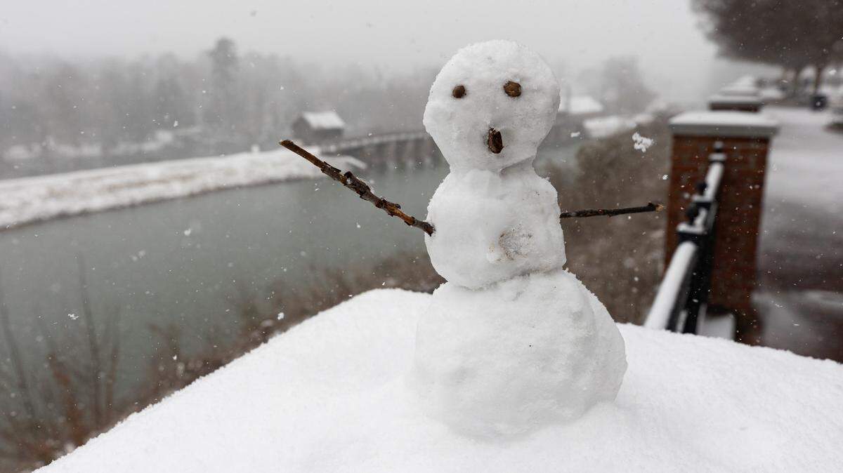 A snow man waves as the snow continues to fall in Columbia, South Carolina on Saturday, January 31, 2026.