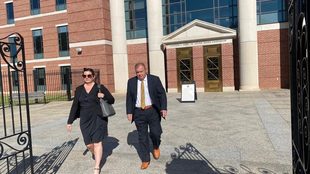 Carl Churchman (r) leaves the federal courthouse in Columbia SC with his lawyer, Lauren Williams, on Tuesday, Oct. 17, 2023, after being sentenced to six months home detention for lying to an FBI agent.