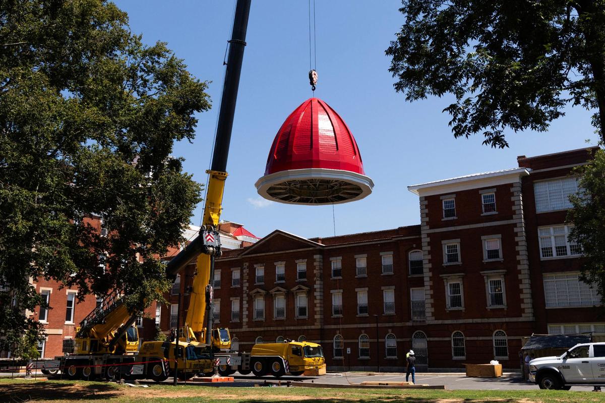 Workers install the new cupola dome at the Babcock building on Friday, August 18, 2023.