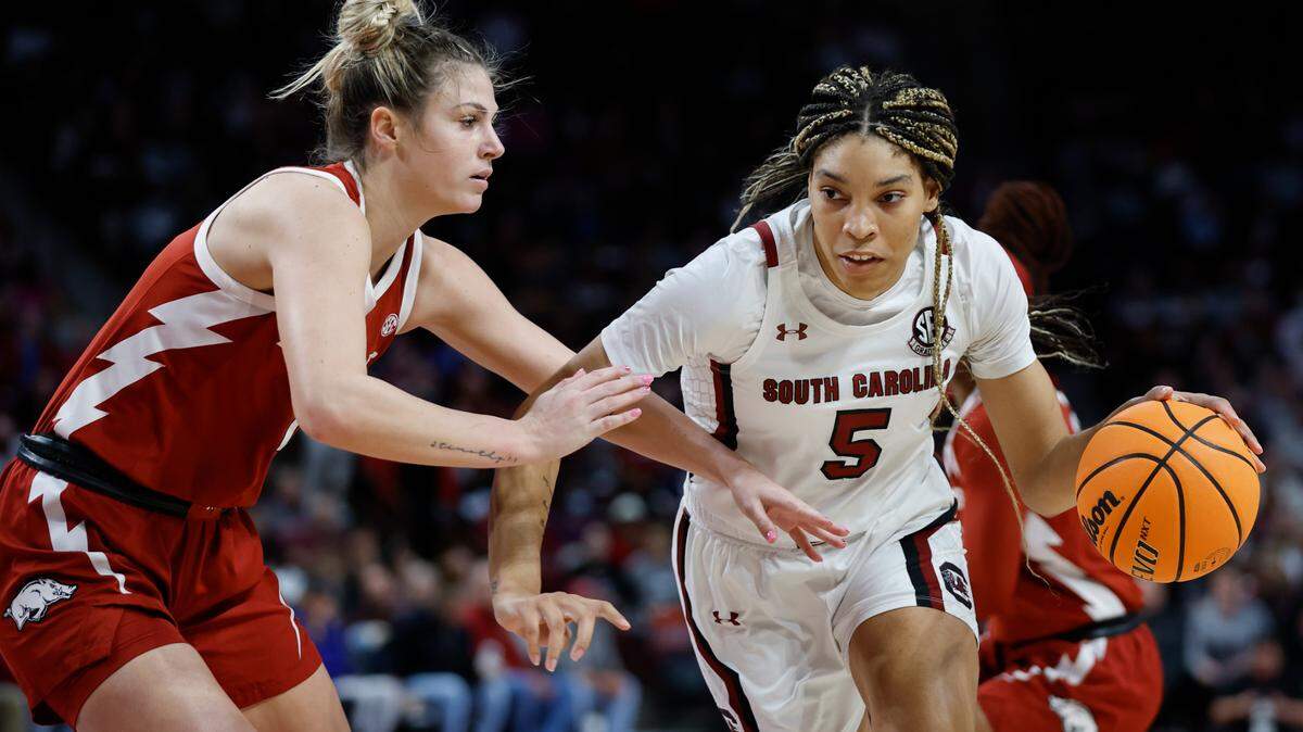 South Carolina forward Victaria Saxton (5) drives against Arkansas guard Saylor Poffenbarger during the first half of an NCAA college basketball game in Columbia, S.C., Sunday, Jan. 22, 2023. (AP Photo/Nell Redmond)