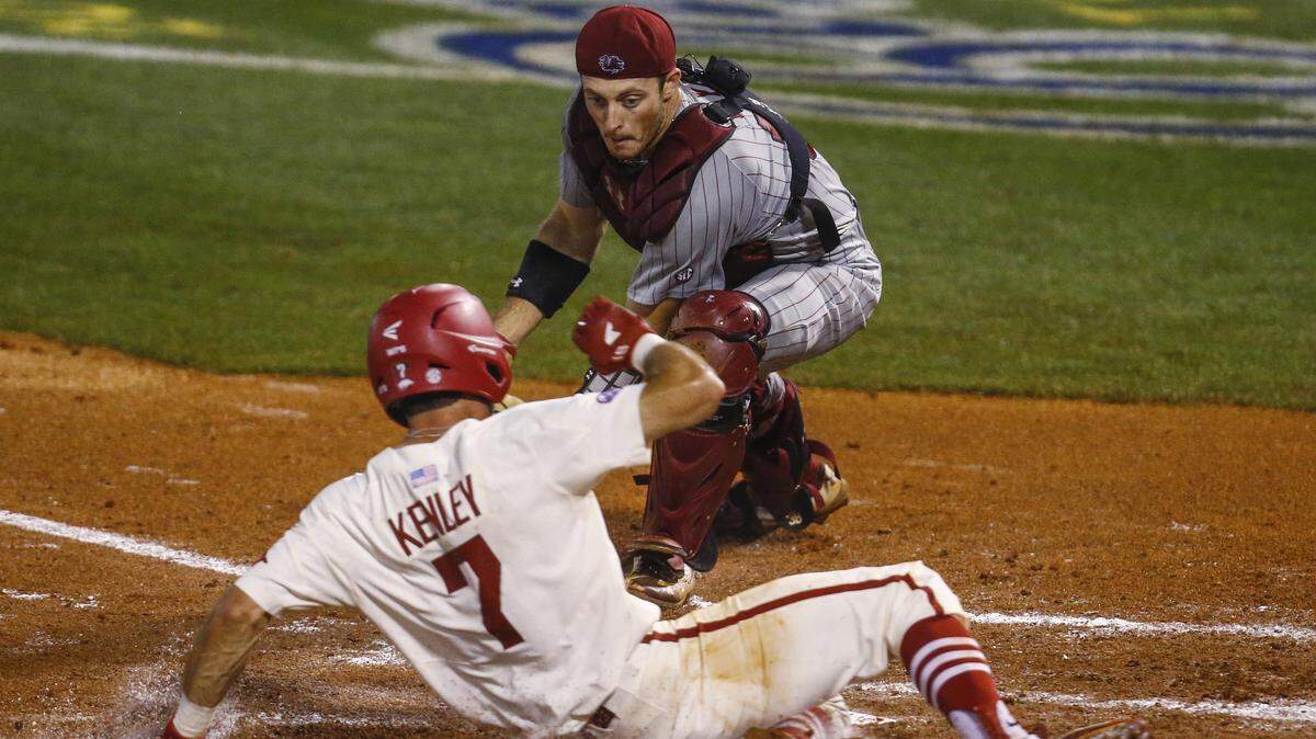 Arkansas' Jack Kenley (7) beats the tag from South Carolina catcher Hunter Taylor (38) as he scores during the second inning of a Southeastern Conference tournament NCAA college baseball game Wednesday, May 23, 2018, in Hoover, Ala.