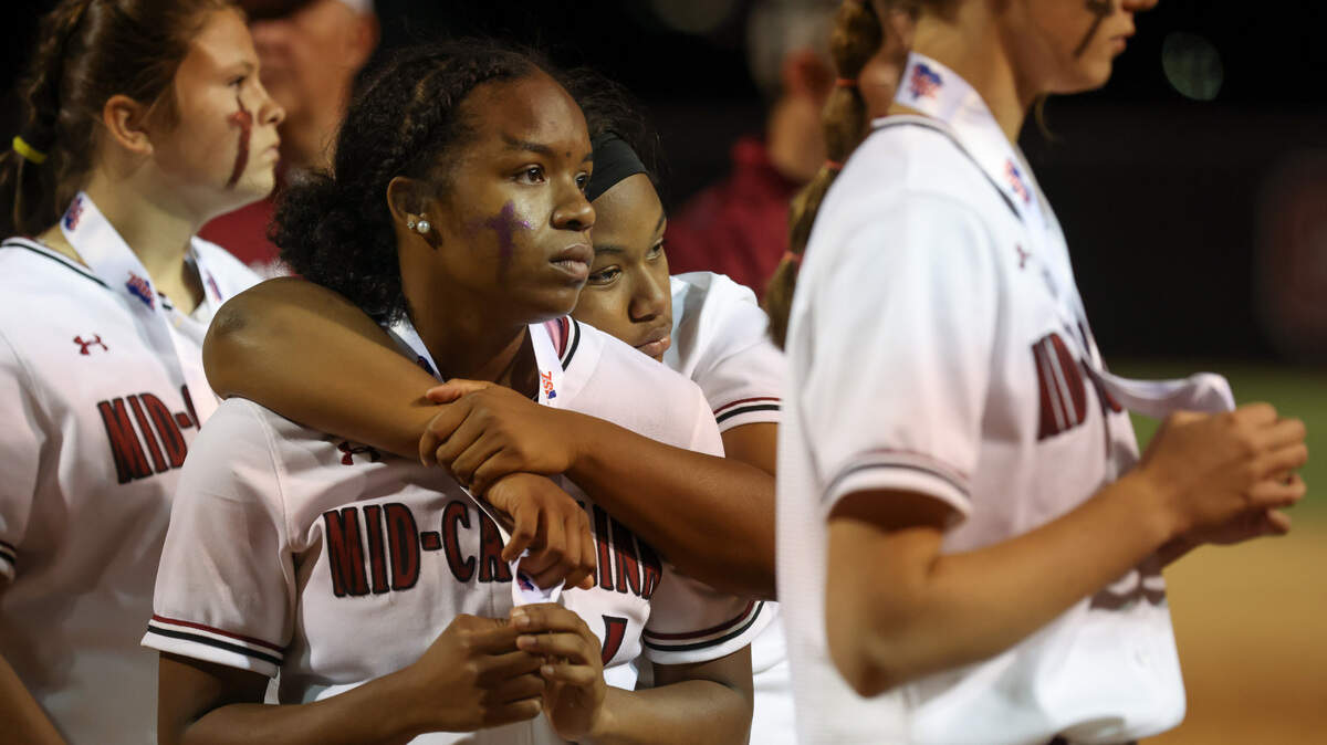 Jaila Gallman (10) of Mid-Carolina hugs teammate Samara Bowers (1) following their team’s loss to Chesterfield in the SCHSL Class 2A Softball State Championship at Carolina Softball Stadium in Columbia on Friday, May 26, 2023.