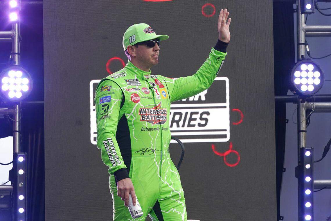 Kyle Busch waves to fans during driver introductions before the NASCAR Cup Series auto race at Daytona International Speedway, Saturday, Aug. 28, 2021, in Daytona Beach, Fla. (AP Photo/John Raoux)