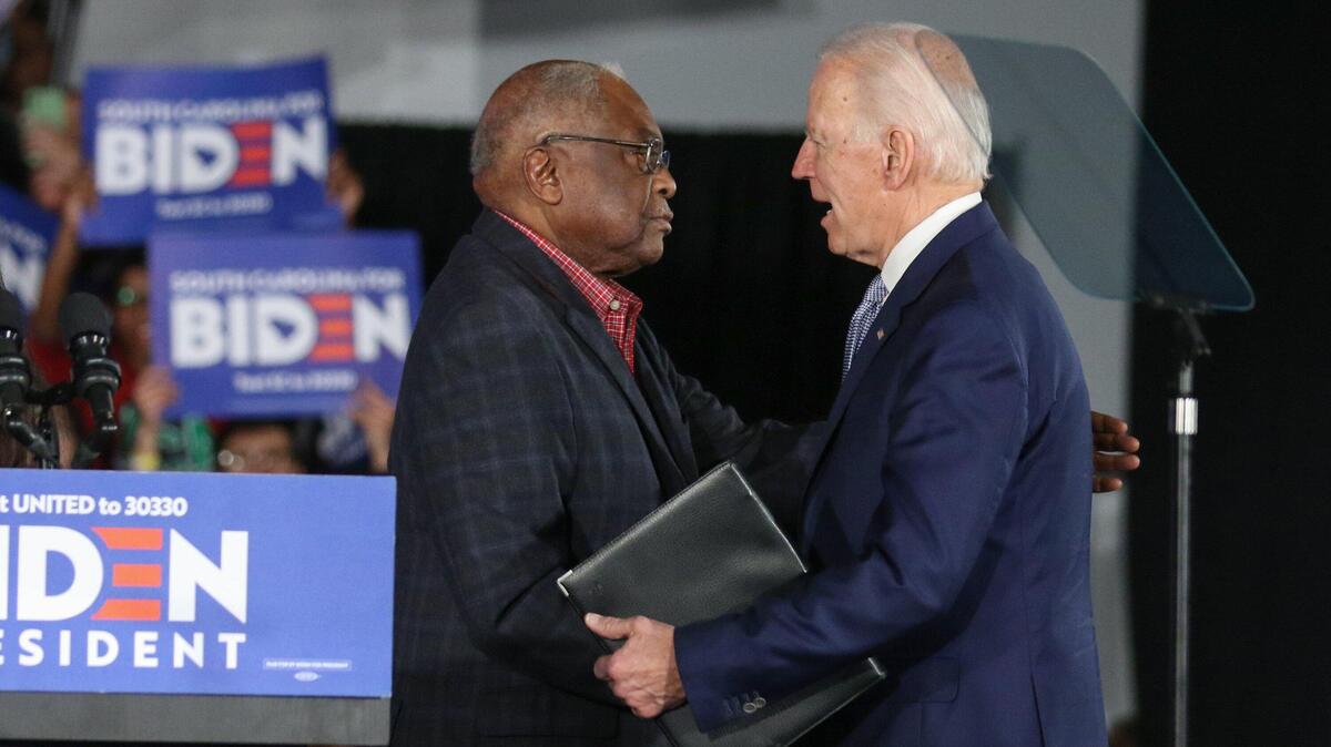 Joe Biden greets Jim Clyburn before speaking during a celebration at the University of South Carolina volleyball center. 2/29/20
