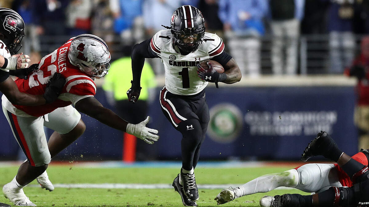 Rahsul Faison #1 of the South Carolina Gamecocks carries the ball against Will Echoles #52 of the Mississippi Rebels during the second half at Vaught-Hemingway Stadium on November 01, 2025 in Oxford, Mississippi.
