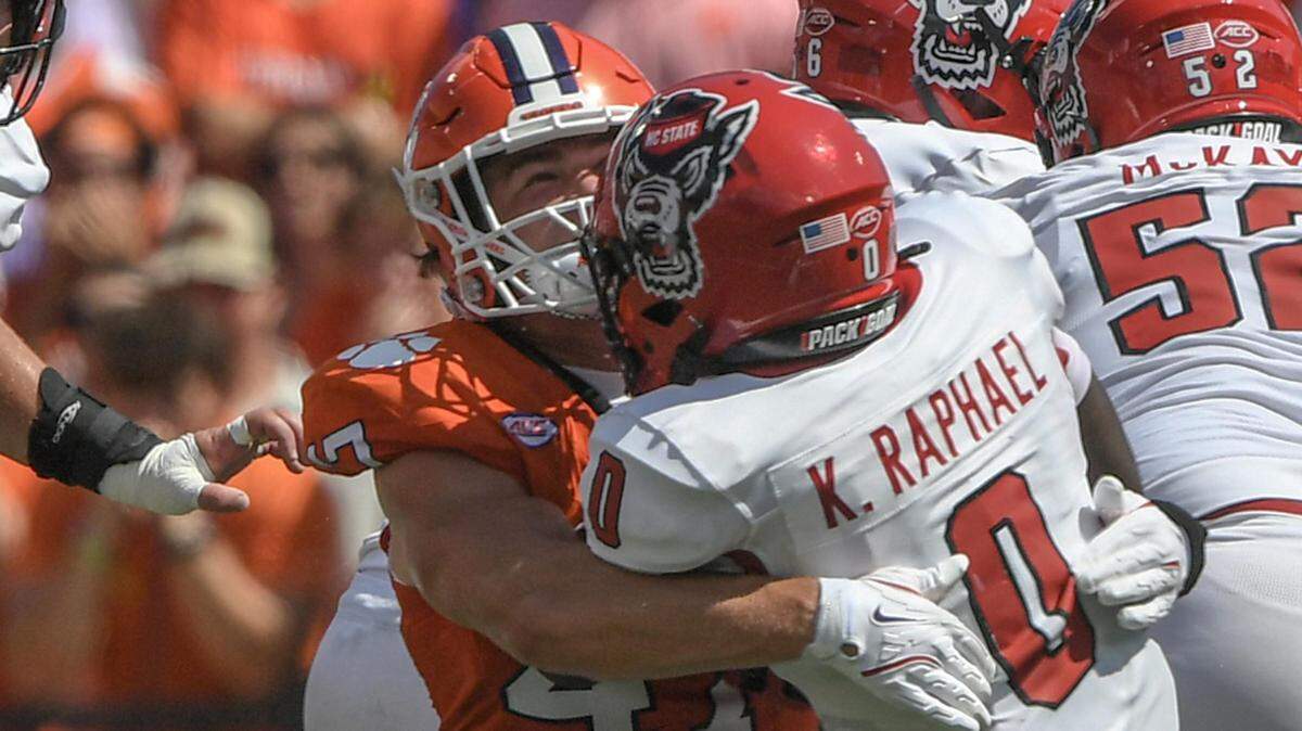 Clemson Tigers linebacker Sammy Brown (47) tackles North Carolina State Wolfpack running back Kendrick Raphael (0) for a loss during their game at Memorial Stadium.