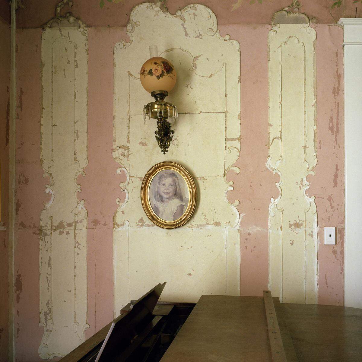 Kathleen Robbins’ photo, “Ashwood,” depicts a room in a family friend’s aging Southern home. It holds precious memories from a different time, but it is in a state of disrepair. The image’s combination of nostalgia and decay offers a bittersweet reminder of the inevitable passage of time.