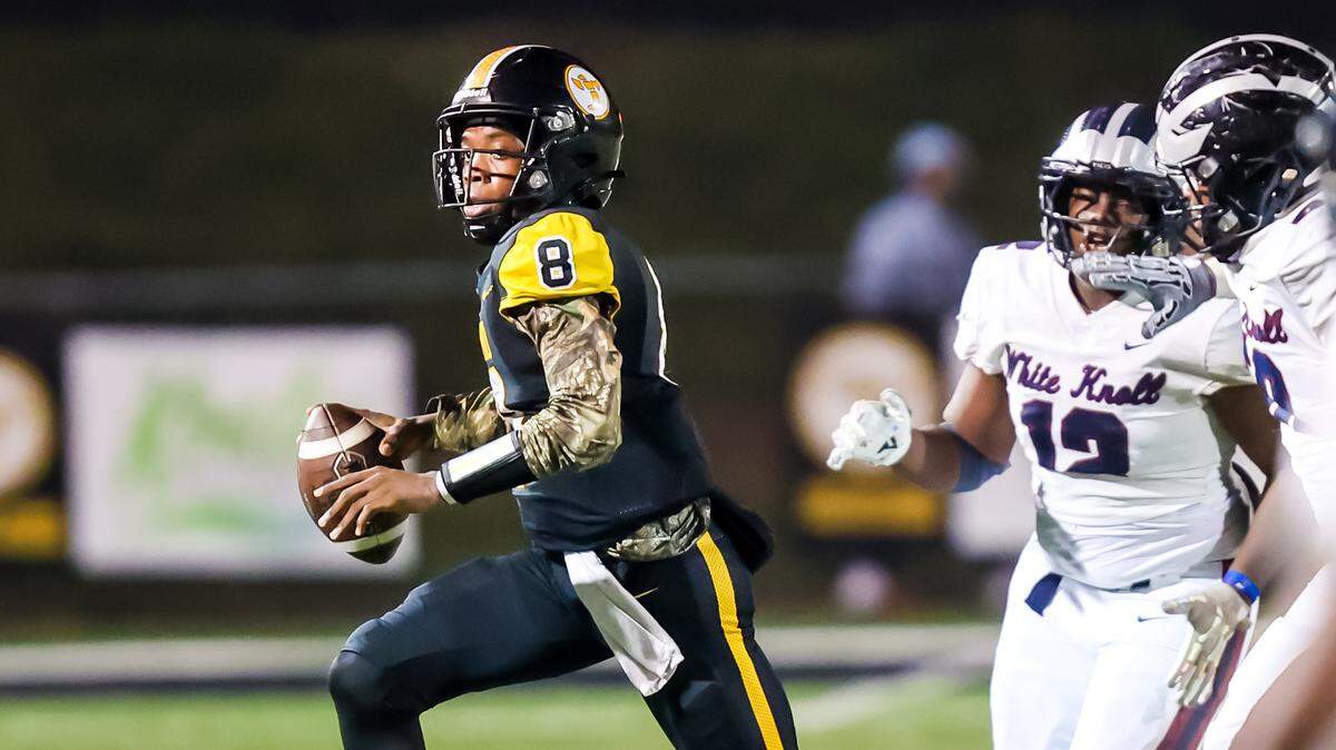 Irmo Yellowjackets quarterback Drevon Dopson (8) runs for a first down against the White Knoll Timberwolves during their game at Irmo High School Friday evening, 11/21/25.