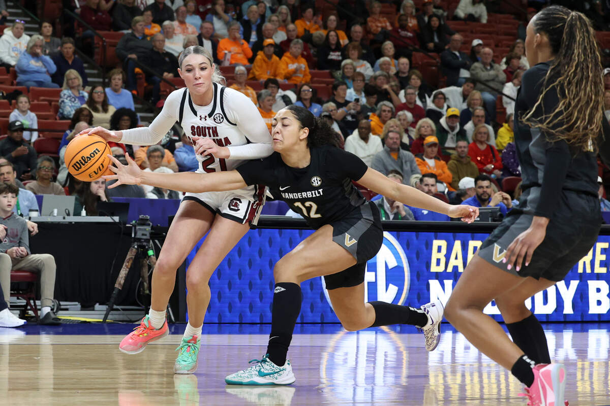 University of South Carolina’s Chloe Kitts (21) keeps the ball from Vanderbilt’s Khamil Pierre (12) during the first half of action in the SEC Tournament at the Bon Secours Wellness Arena in Greenville on Friday, Mar. 7, 2025.