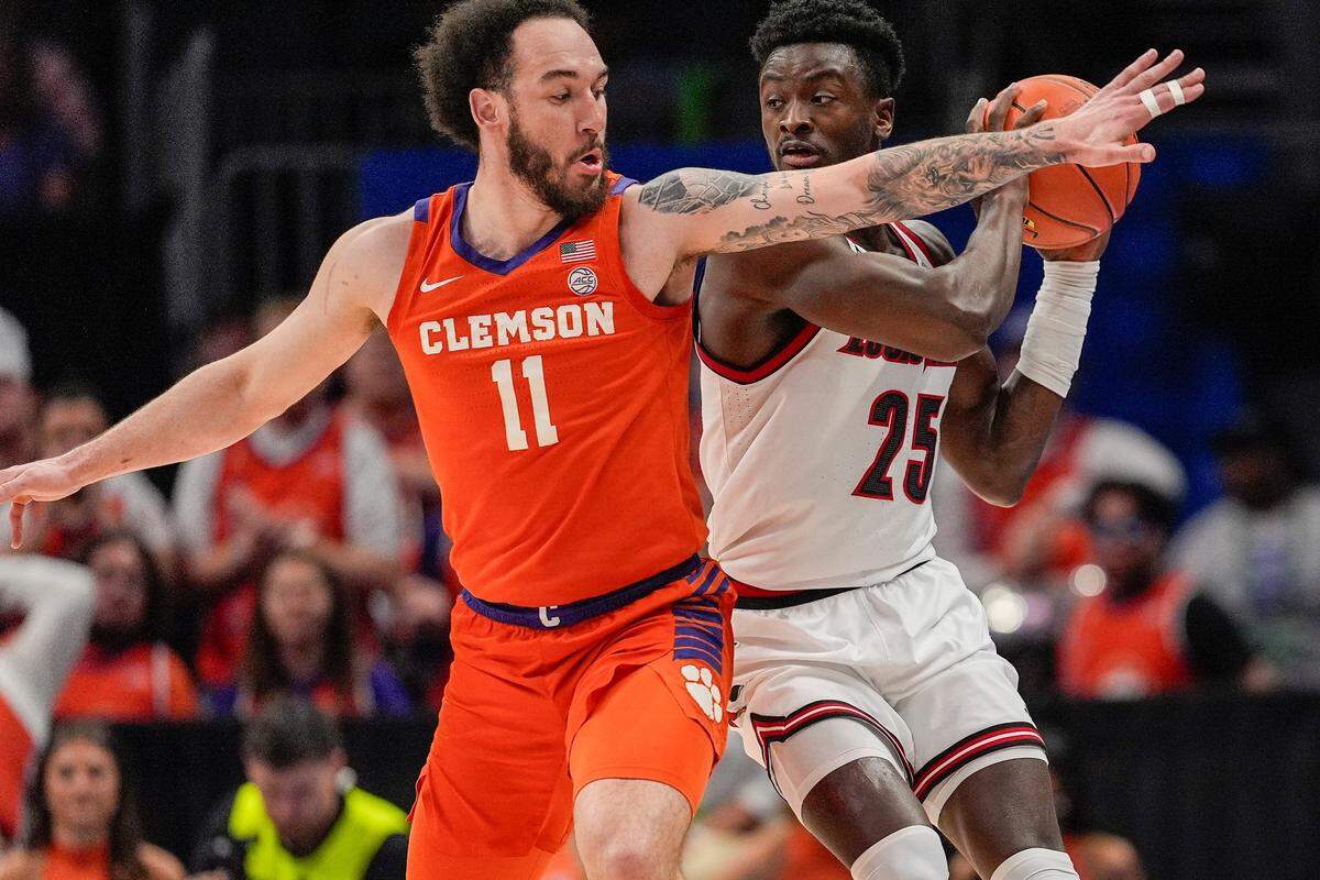Louisville Cardinals forward Aboubacar Traore (25) handles the ball against Clemson Tigers guard Jaeden Zackery (11) during the first half at Spectrum Center.