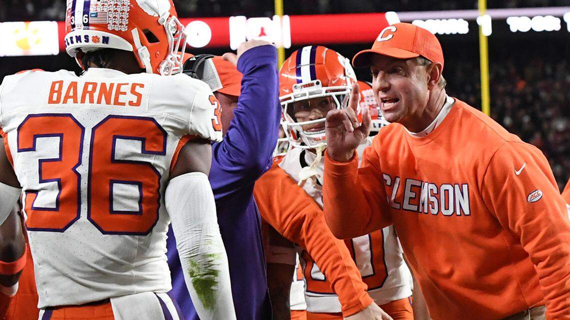 Clemson Tigers head coach Dabo Swinney celebrates with safety Khalil Barnes (36) after Clemson touchdown against the South Carolina Gamecocks during the first quarter at Williams-Brice Stadium.