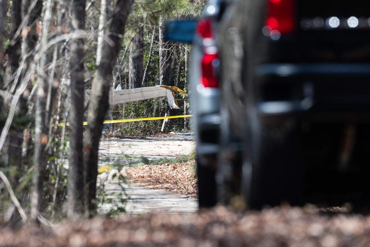 Emergency personnel stage along Windy Road near a crashed plane in Gilbert, South Carolina on Friday, February 6, 2026. 