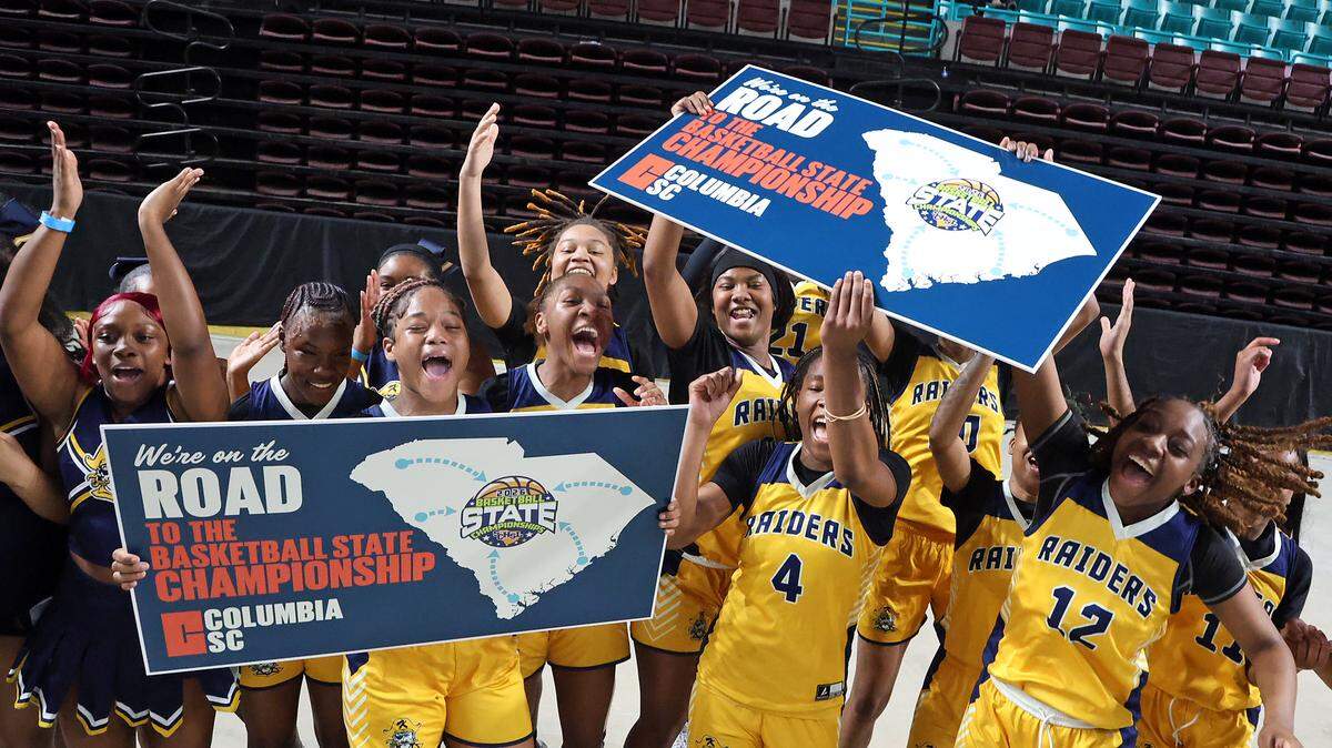 Keenan High School's girls basketball team celebrates its Class 3A Lower State championship win over Oceanside Collegiate on Saturday at the Florence Center. 

