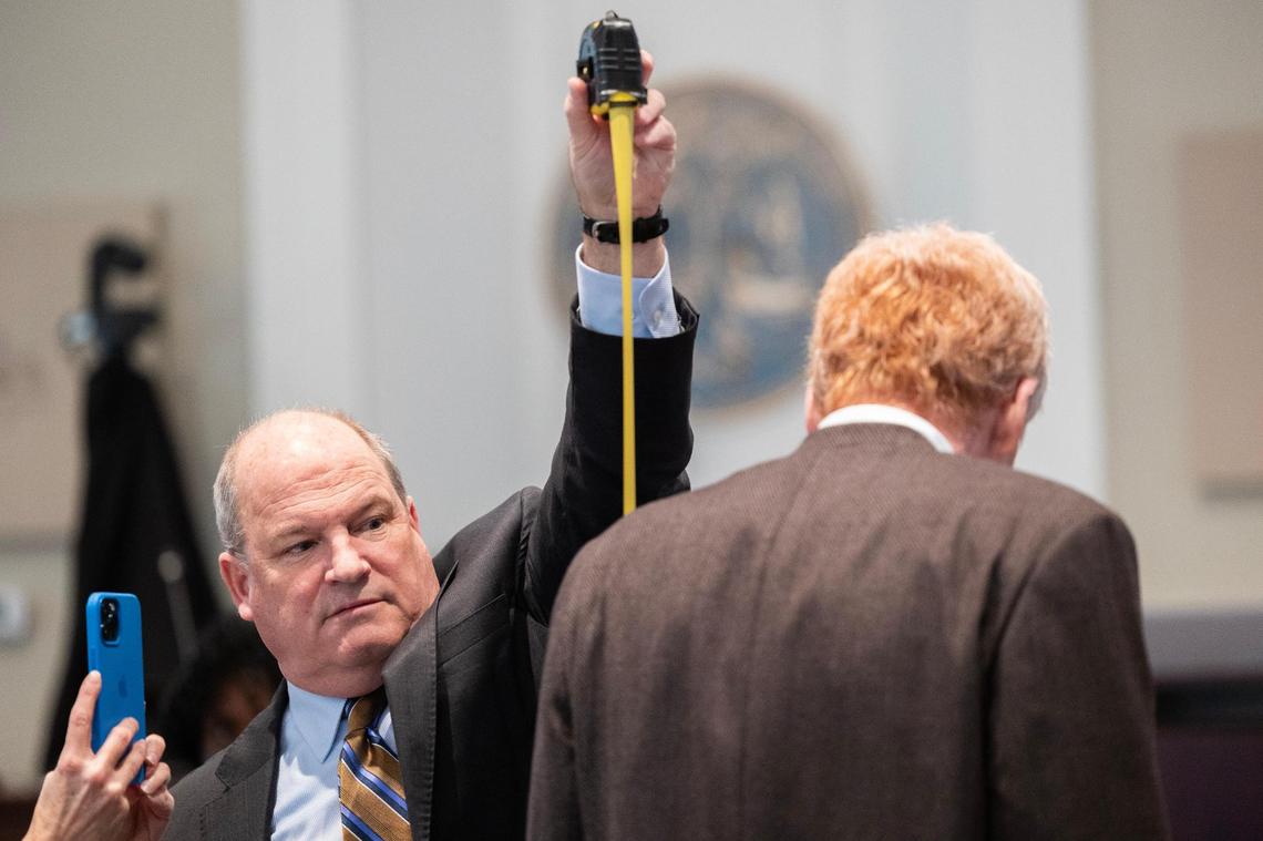 Defense attorney Jim Griffin measures Alex Murdaugh during a break in his trial for murder at the Colleton County Courthouse on Thursday, February 16, 2023. Joshua Boucher/The State/Pool