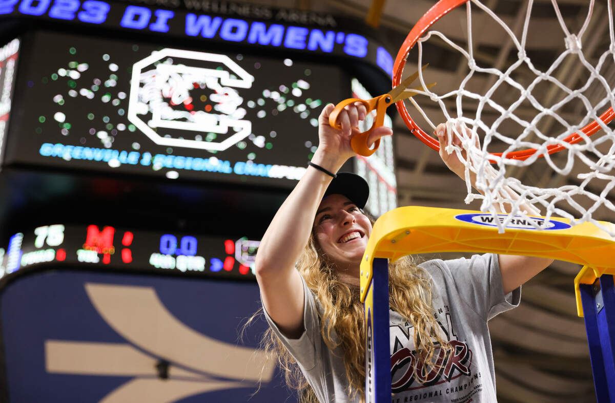 South Carolina Gamecocks guard Olivia Thompson (0) cuts down the net following her team’s win over Maryland in the Elite 8 round of the 2023 NCAA Tournament at Bon Secours Wellness Arena in Greenville on Monday, March 27, 2023.