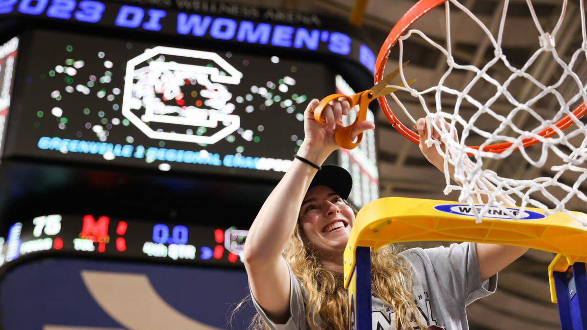 South Carolina Gamecocks guard Olivia Thompson (0) cuts down the net following her team’s win over Maryland in the Elite 8 round of the 2023 NCAA Tournament at Bon Secours Wellness Arena in Greenville on Monday, March 27, 2023.