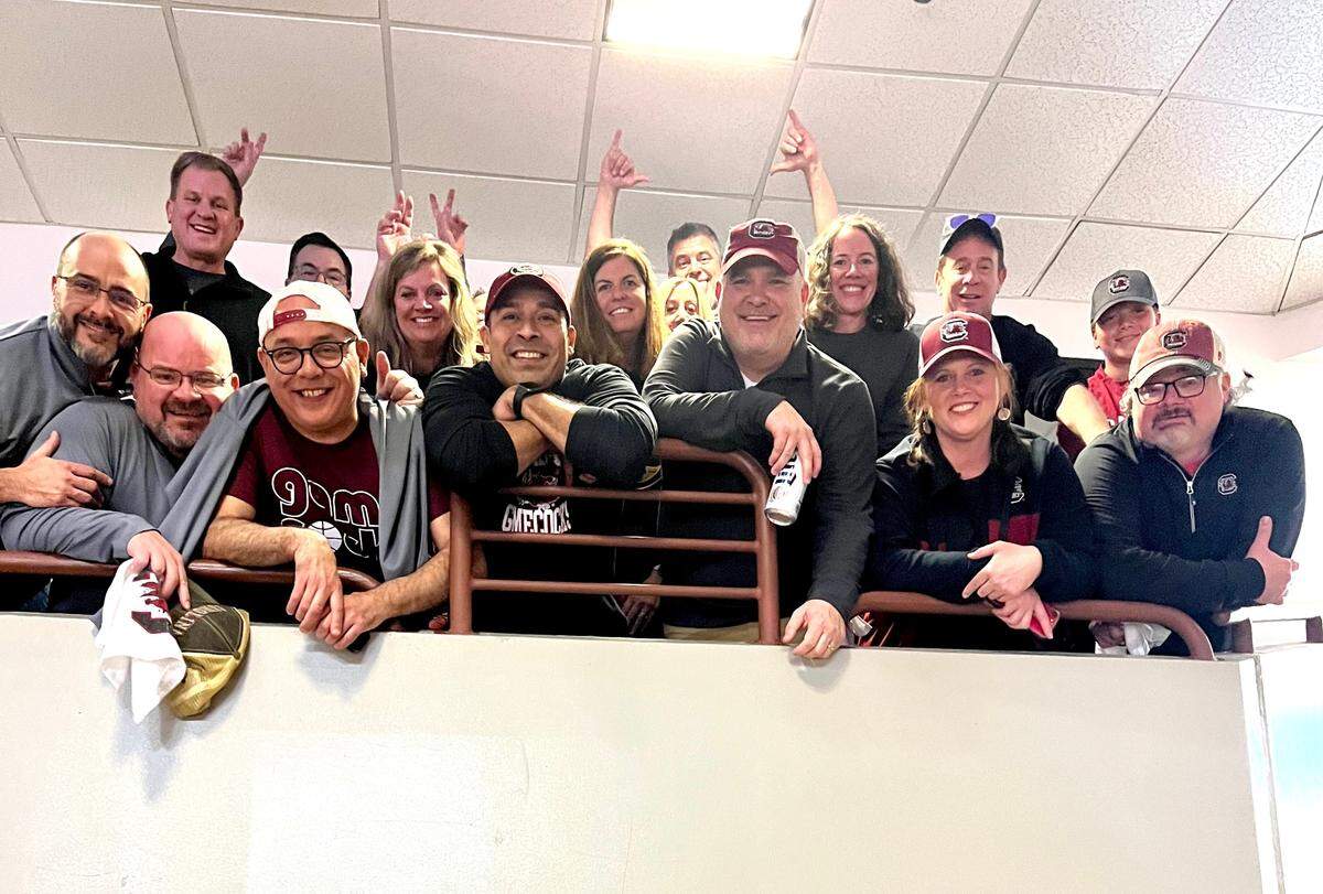 In the suite at Colonial Life Arena, Lamont Paris’ friends from Findlay High School pose for a picture.