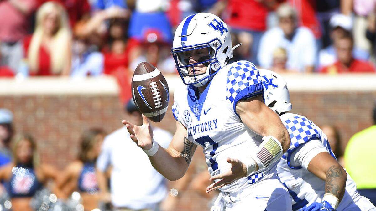 Kentucky quarterback Will Levis (7) bobbles a snap during the first half of an NCAA college football game against Mississippi in Oxford, Miss., Saturday, Oct. 1, 2022. (AP Photo/Thomas Graning)