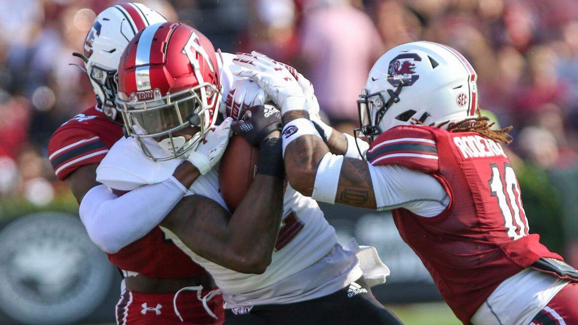 South Carolina’s defensive back Marcellas Dial (24) and defensive back R.J. Roderick (10) take down Troy’s wide receiver Tez Johnson (15) as the Gamecocks take on Troy on Saturday, Oct. 2, 2021 at Williams-Brice Stadium.