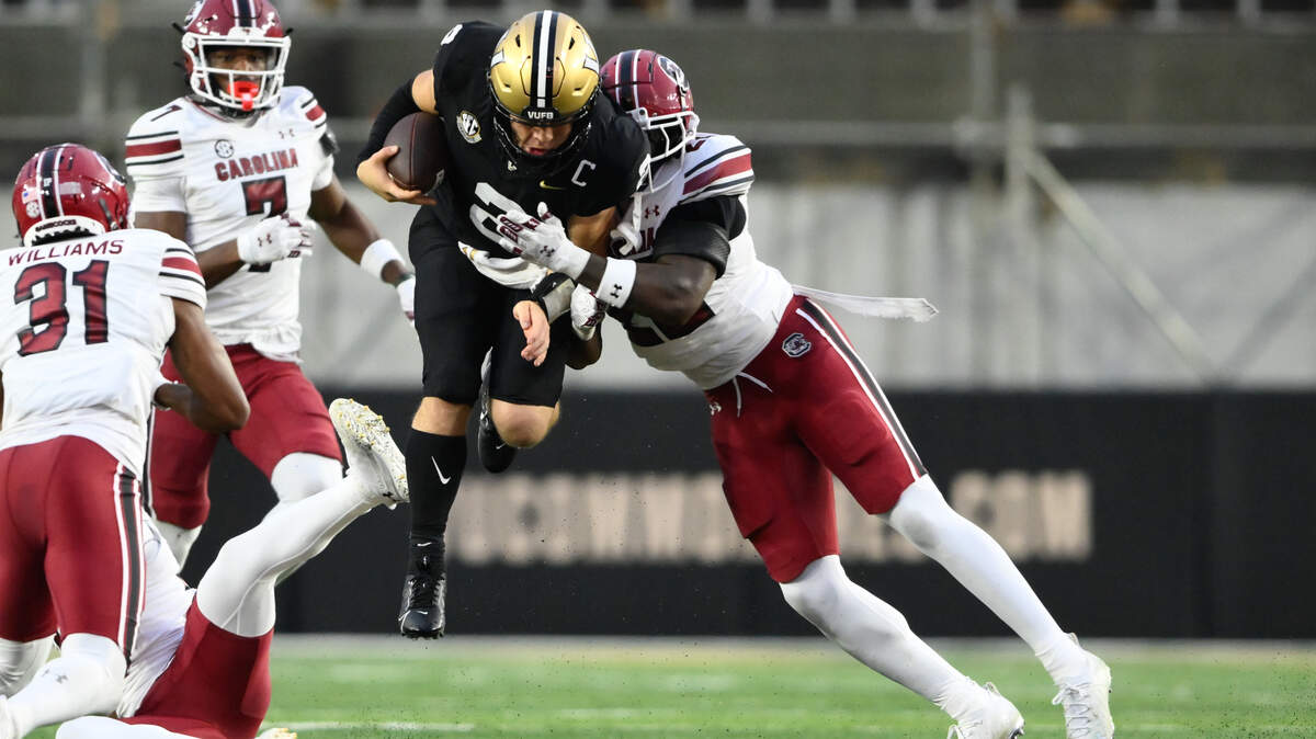 Nov 9, 2024; Nashville, Tennessee, USA;  South Carolina Gamecocks edge Jatius Geer (12) tackles Vanderbilt Commodores quarterback Diego Pavia (2) during the first half at FirstBank Stadium. Mandatory Credit: Steve Roberts-Imagn Images